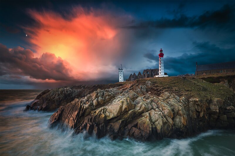 Lighthouse on Rocky Coast — Red, Dramatic, Sunset, Photograph, Ruins