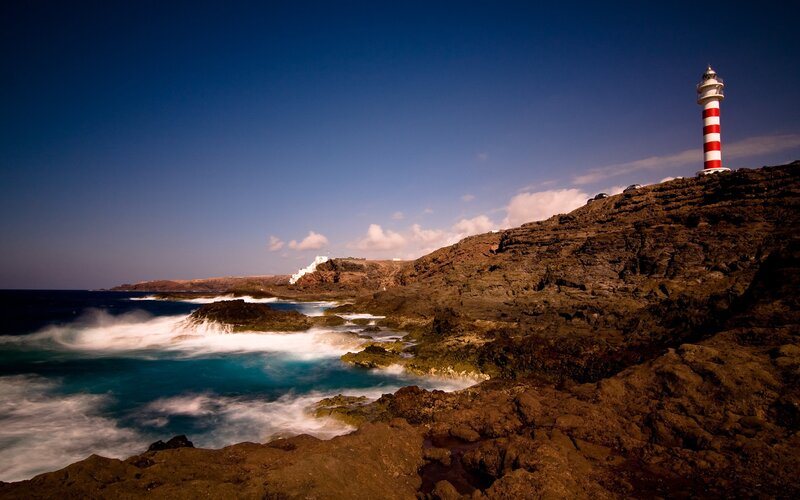Lighthouse on Rocky Coast — Rocks