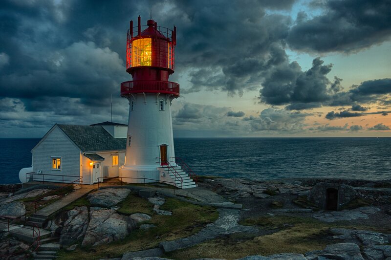 Lighthouse on Rocky Coast — White, Dramatic, Sunset, Photograph, Ocean