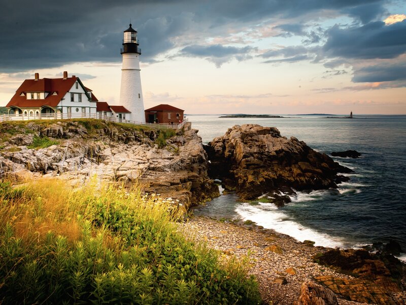 Lighthouse on Rocky Coast — White, Dramatic, Sunset