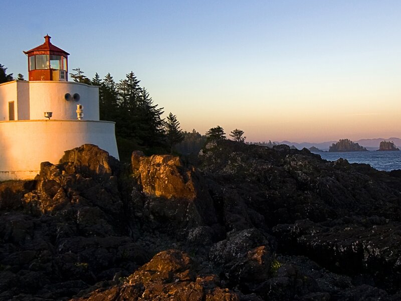 Lighthouse on Rocky Coast — White, Serene, Sunset