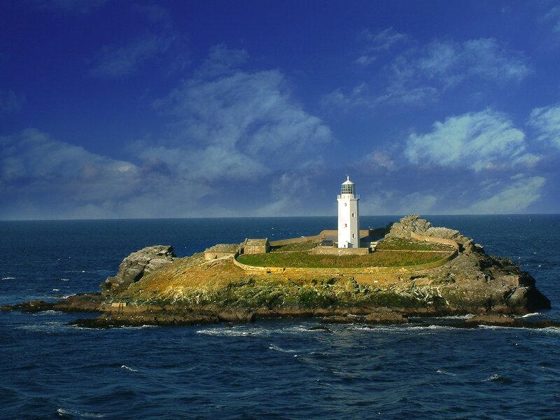 Lighthouse on Rocky Island — Blue, Dramatic, Afternoon, Photograph, Ocean, Sky