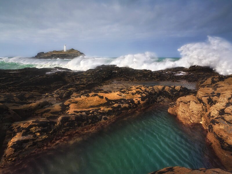 Lighthouse on Rocky Island — Blue, Dramatic, Afternoon, Photograph, Ocean Waves, Rocky Shore, Clouds