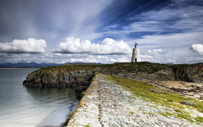 Lighthouse on Rocky Island — Blue, Dramatic, Afternoon, Photograph, Sea, Mountains