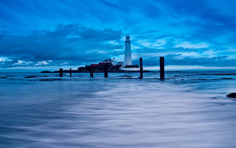 Lighthouse on Rocky Island — Blue, Dramatic, Night, Photograph, Clouds, Sea