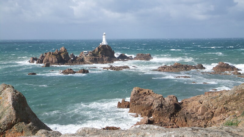Lighthouse on Rocky Island — Blue, Dramatic, Photograph, Ocean