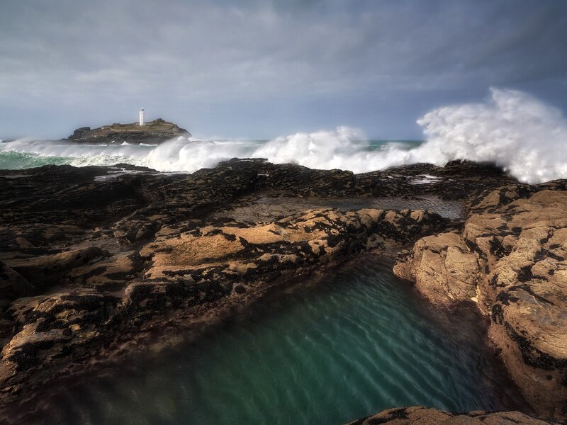 Lighthouse on Rocky Island — Blue, Dramatic, Photograph, Ocean Waves, Rocky Shore, Clouds