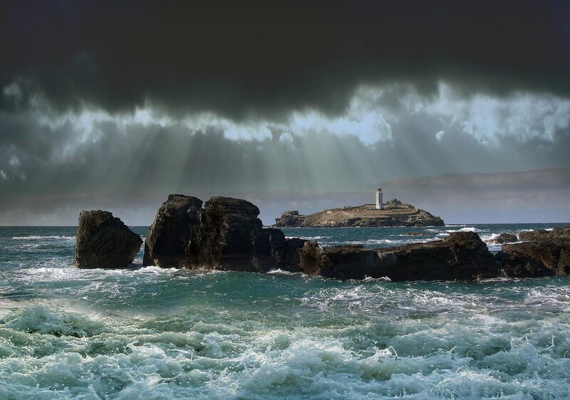 Lighthouse on Rocky Island — Blue, Dramatic, Photograph, Rocks