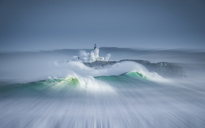 Lighthouse on Rocky Island — Blue, Dramatic, Photograph, Waves, Sea, Cliffs