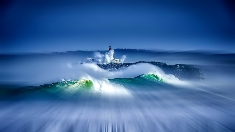 Lighthouse on Rocky Island — Blue, Dramatic, Photograph, Waves