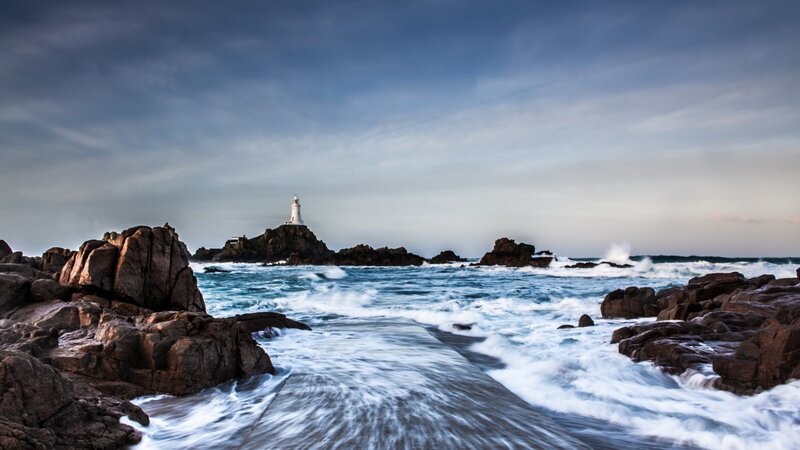 Lighthouse on Rocky Island — Blue, Dramatic, Sunset, Photograph, Ocean, Rocks