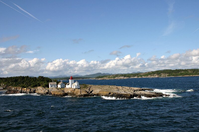 Lighthouse on Rocky Island — Blue, Serene, Afternoon, Photograph, Ocean, Clouds