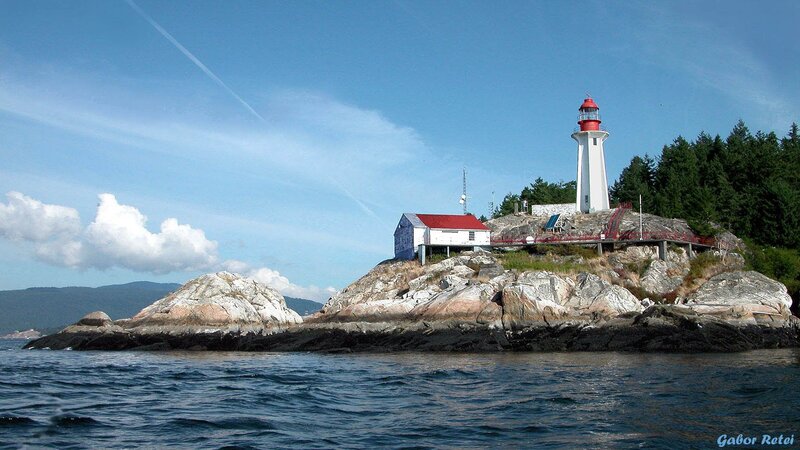 Lighthouse on Rocky Island — Blue, Serene, Afternoon, Photograph, Ocean, Trees, Sky