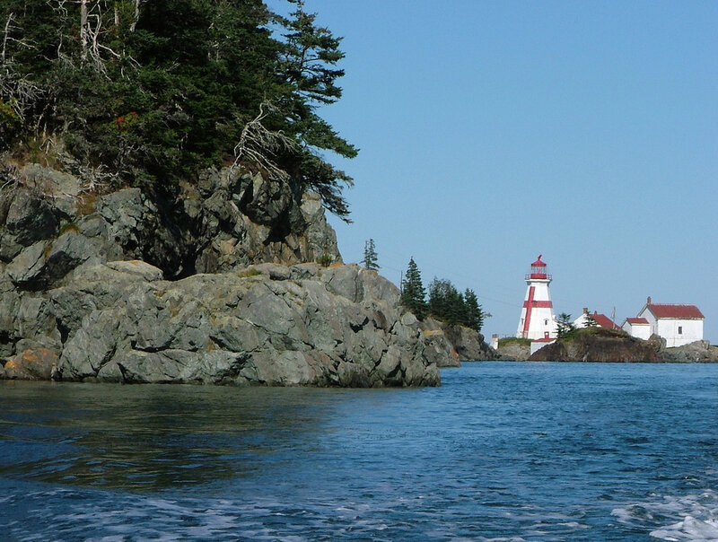 Lighthouse on Rocky Island — Blue, Serene, Afternoon, Photograph, Rocks, Trees