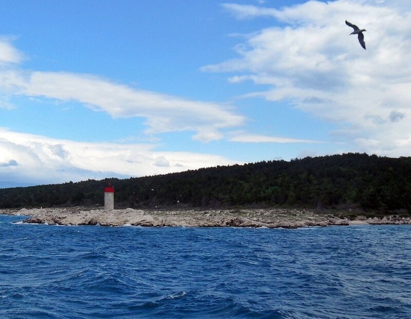 Lighthouse on Rocky Island — Blue, Serene, Afternoon