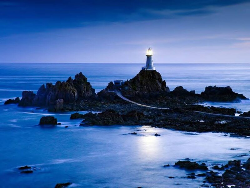 Lighthouse on Rocky Island — Blue, Serene, Night, Photograph, Ocean, Rocks