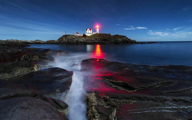 Lighthouse on Rocky Island — Blue, Serene, Night, Photograph, Rocks, Ocean