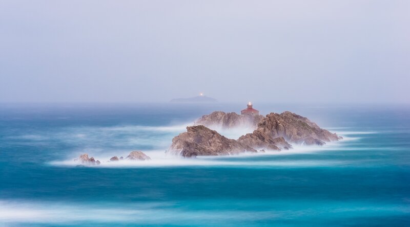 Lighthouse on Rocky Island — Blue, Serene, Photograph