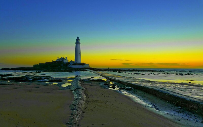 Lighthouse on Rocky Island — Blue, Serene, Sunset, Photograph, Ocean, Beach