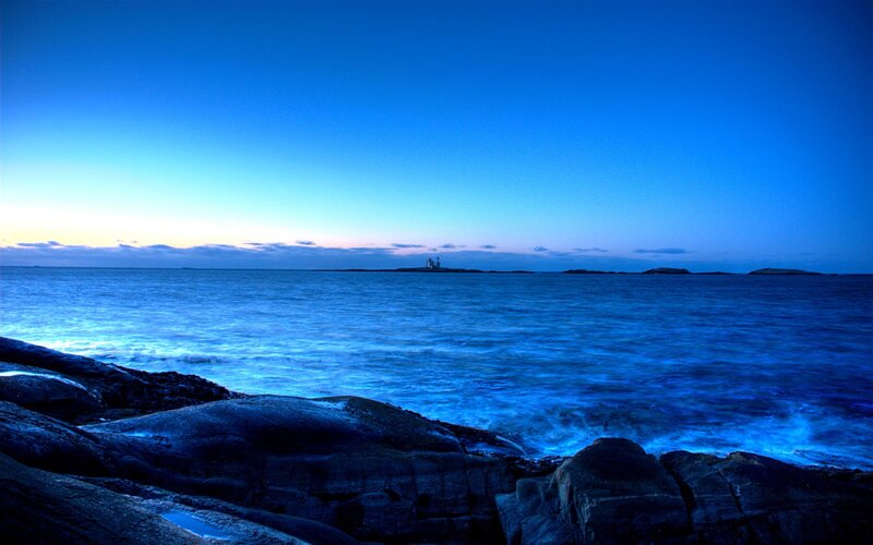 Lighthouse on Rocky Island — Blue, Serene, Sunset, Photograph, Ocean