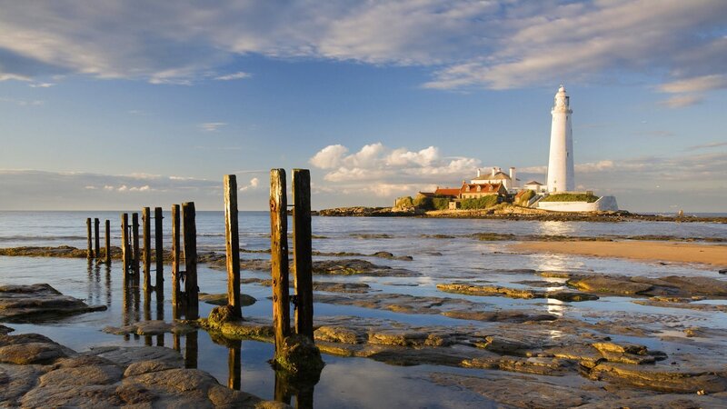 Lighthouse on Rocky Island — Blue, Serene, Sunset, Photograph, Sea, Rocks