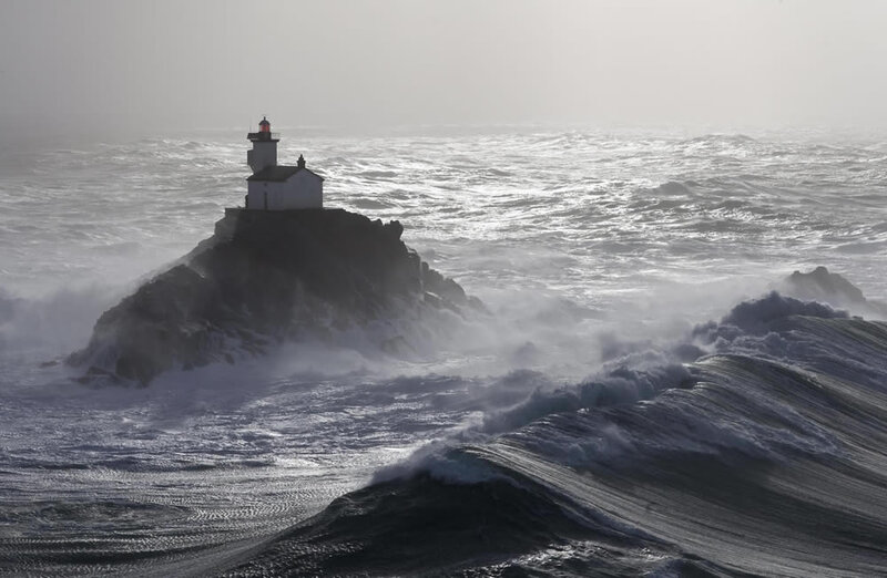 Lighthouse on Rocky Island — Gray, Dramatic, Photograph, Ocean