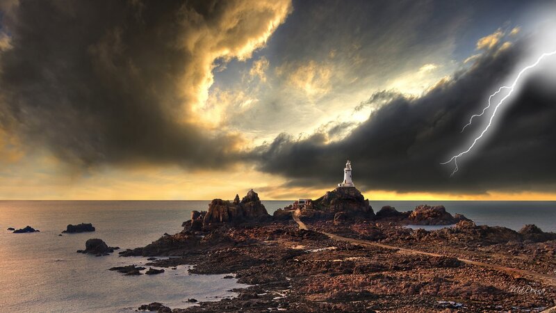 Lighthouse on Rocky Island — Gray, Dramatic, Sunset, Photograph, Lightning