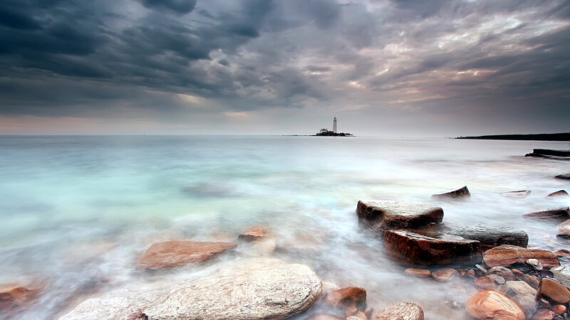 Lighthouse on Rocky Island — Gray, Dramatic, Sunset, Photograph, Ocean