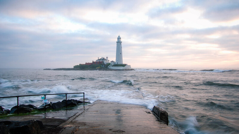 Lighthouse on Rocky Island — Gray, Dramatic, Sunset, Photograph, Ocean, Waves