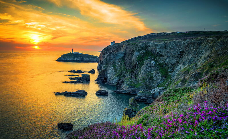 Lighthouse on Rocky Island — Orange, Dramatic, Sunset, Photograph, Cliffs