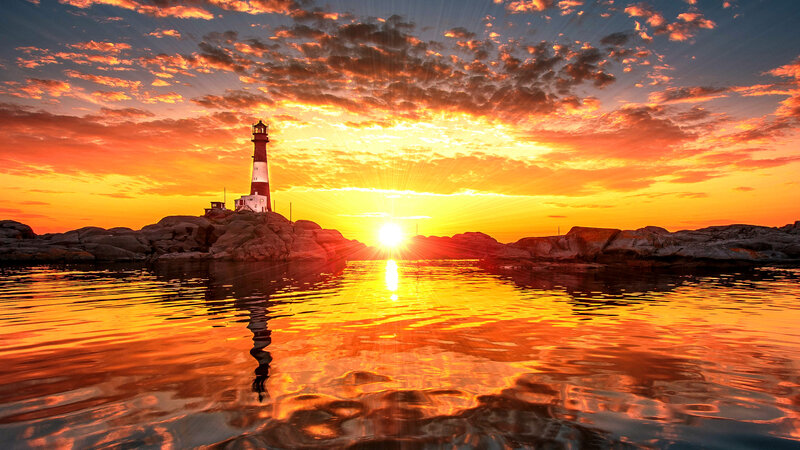 Lighthouse on Rocky Island — Orange, Dramatic, Sunset, Photograph