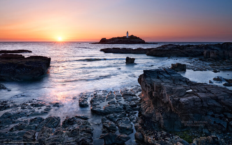 Lighthouse on Rocky Island — Orange, Serene, Sunset, Photograph, Sun