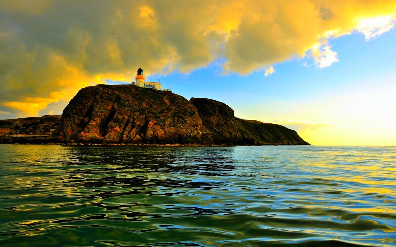Lighthouse on Rocky Island — Yellow, Dramatic, Sunset