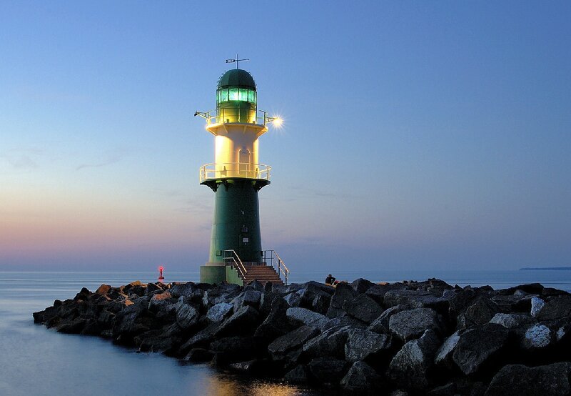 Lighthouse on Rocky Pier — Blue, Serene, Sunset