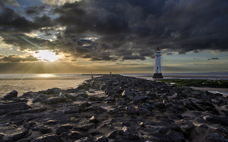 Lighthouse on Rocky Pier — Gray, Dramatic, Sunset