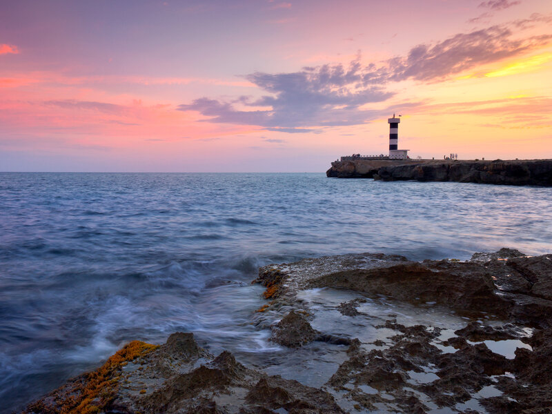 Lighthouse on Rocky Pier — Pink, Serene
