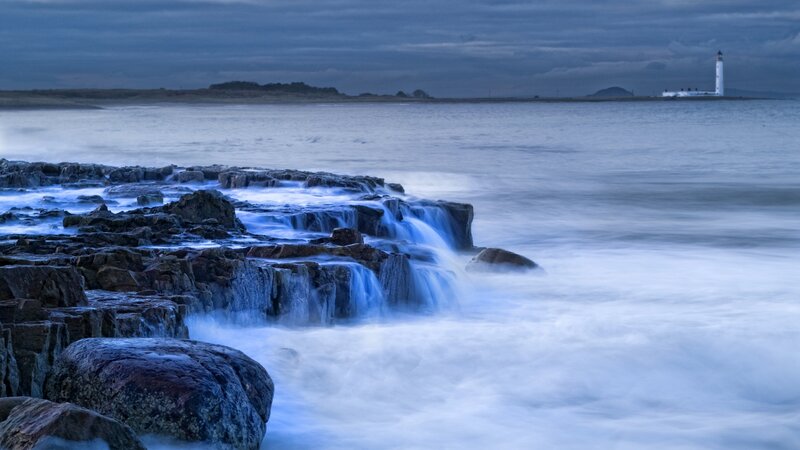 Lighthouse on Rocky Shore — Blue, Calm