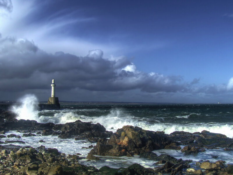 Lighthouse on Rocky Shore — Blue, Dramatic, Afternoon, Photograph