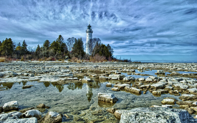 Lighthouse on Rocky Shore — Blue, Dramatic, Autumn, Photograph