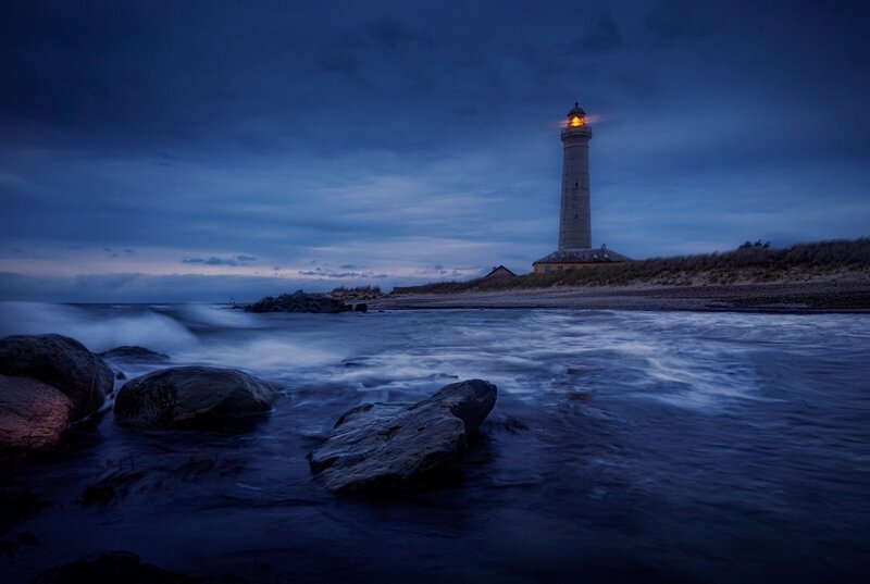 Lighthouse on Rocky Shore — Blue, Dramatic, Night, Photograph, Ocean, Rocks