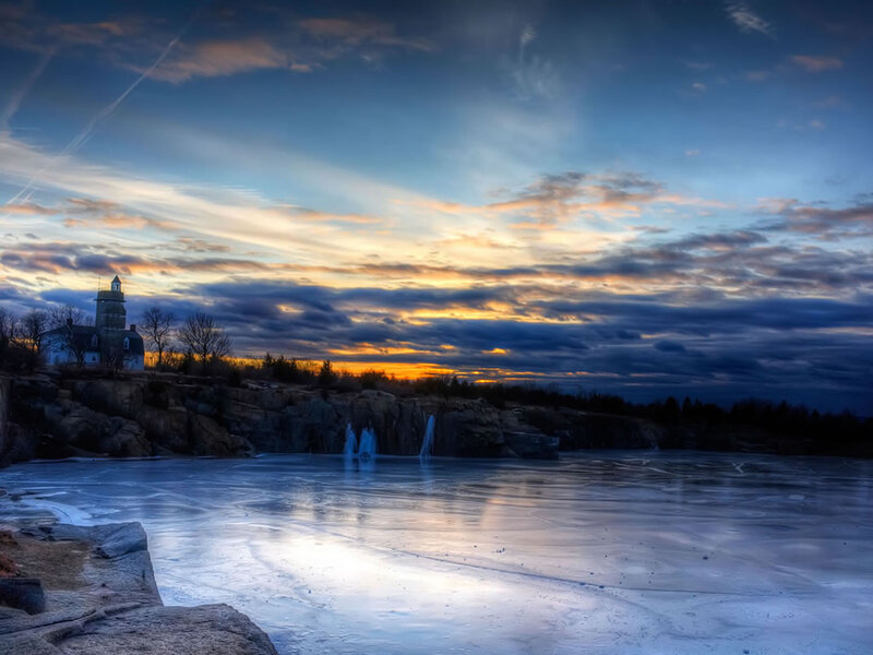Lighthouse on Rocky Shore — Blue, Dramatic, Sunset, Photograph, Frozen Lake