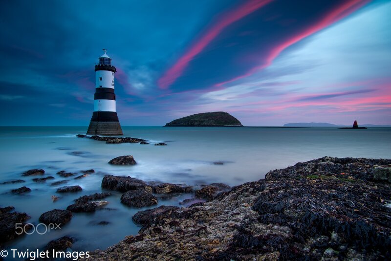 Lighthouse on Rocky Shore — Blue, Dramatic, Sunset, Photograph, Island