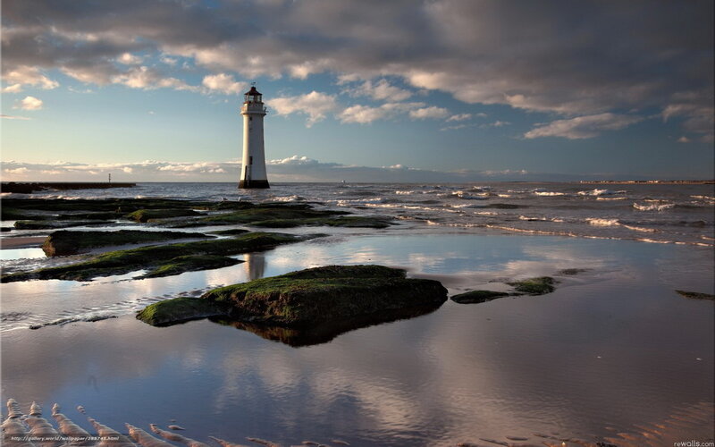 Lighthouse on Rocky Shore — Blue, Dramatic, Sunset, Photograph, Ocean, Clouds