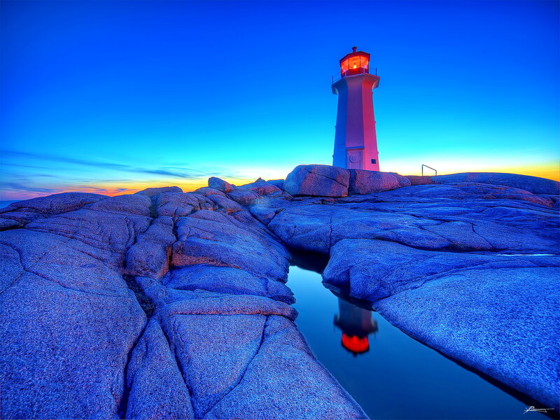 Lighthouse on Rocky Shore — Blue, Dramatic, Sunset, Photograph, Rocks, Sky