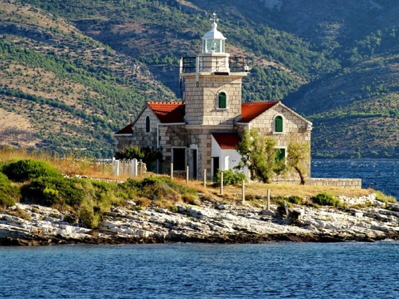 Lighthouse on Rocky Shore — Blue, Serene, Afternoon