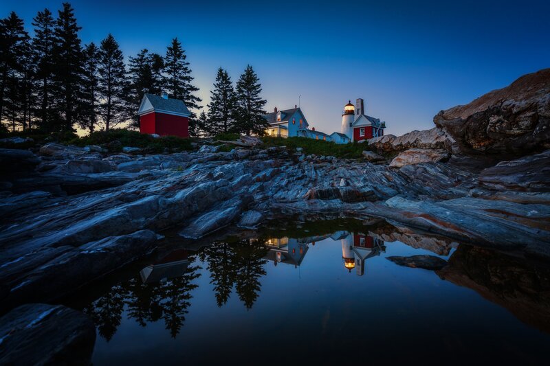 Lighthouse on Rocky Shore — Blue, Serene, Night, Photograph, Buildings