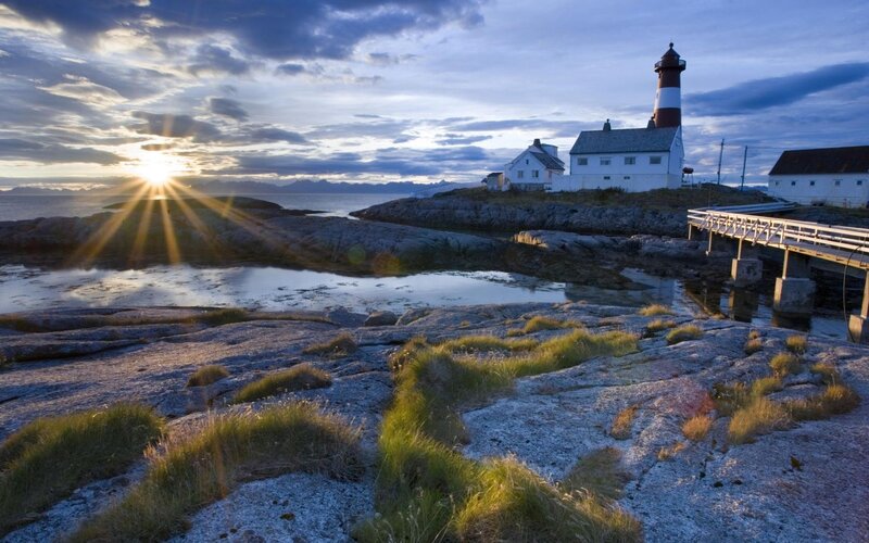 Lighthouse on Rocky Shore — Blue, Serene, Sunrise, Photograph, Sea