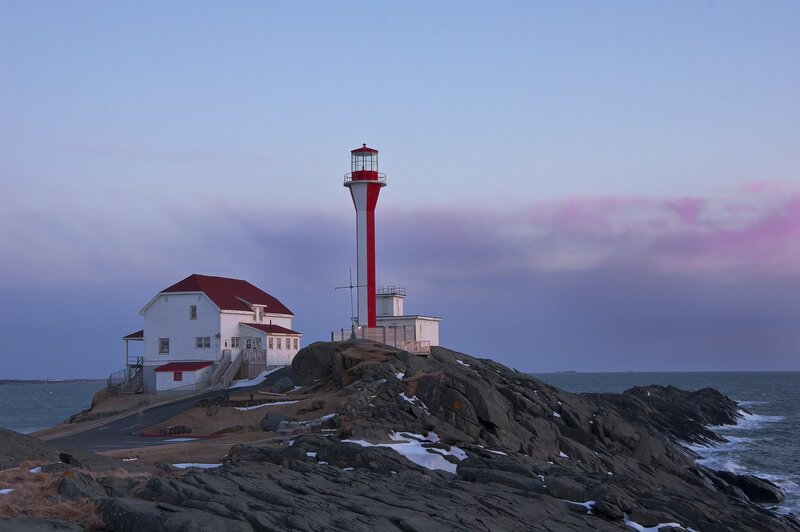 Lighthouse on Rocky Shore — Blue, Serene, Sunset, Photograph, Building, Sea