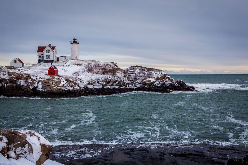 Lighthouse on Rocky Shore — Gray, Serene, Winter, Photograph