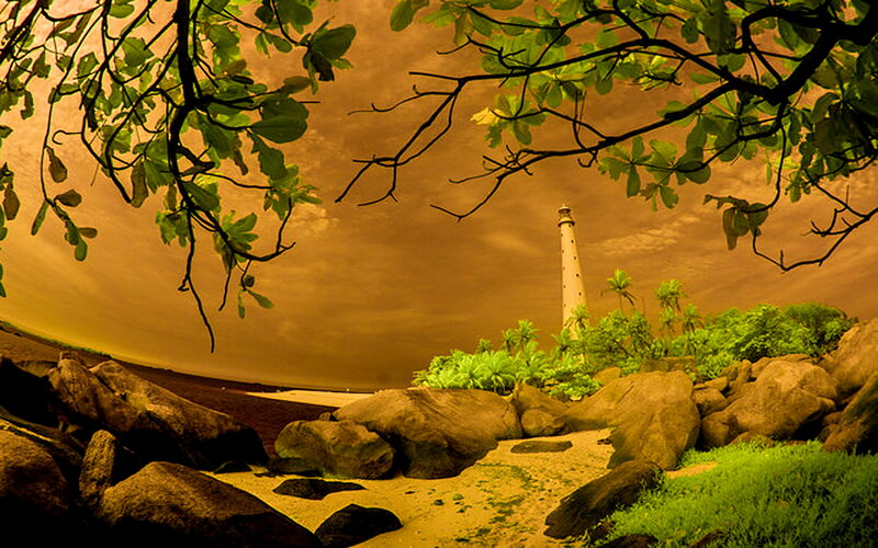 Lighthouse on Rocky Shore — Green, Dramatic, Sunset, Photograph
